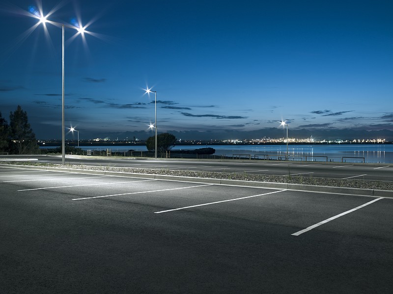 夜间空旷的郊区停车场，临水有路灯图片下载