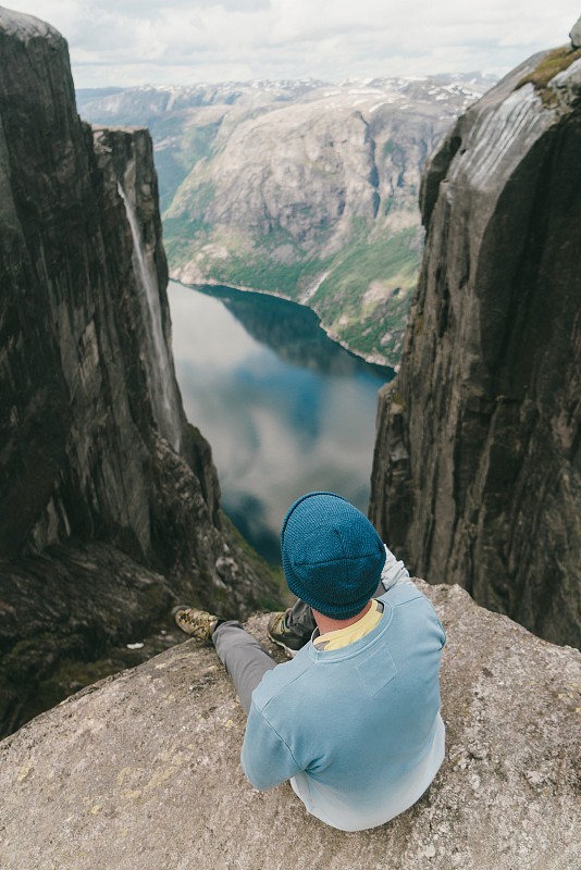一名男子坐在谢格拉山观看吕瑟峡湾的风景图片下载