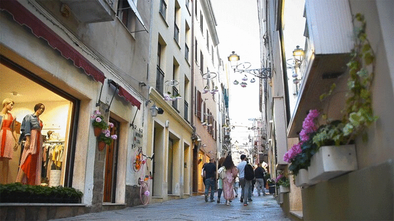 游客穿过撒丁岛阿尔盖罗的窄街图片下载