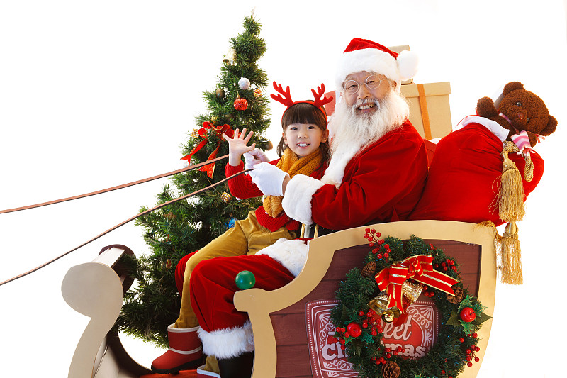 圣诞老人和小女孩坐在雪橇上图片素材