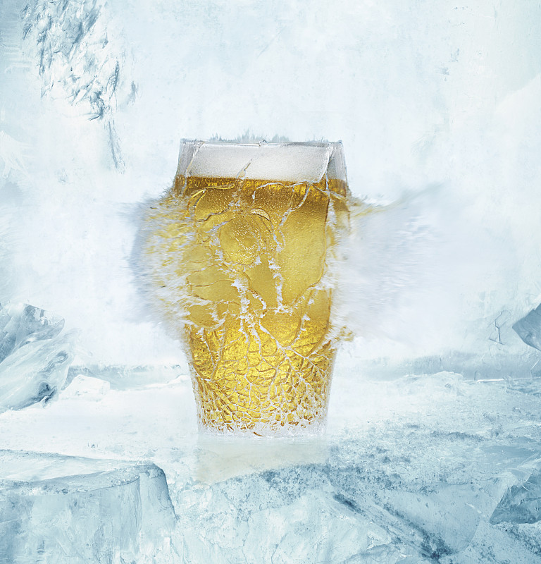 一品脱啤酒玻璃杯在冰上爆炸图片素材