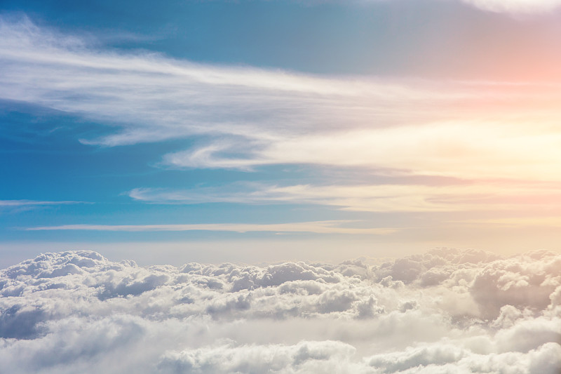 阳光明媚的天空为背景，飞机窗外的云和蓝天图片下载