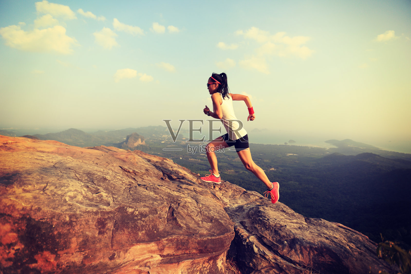 年轻的亚洲女子跑在山顶照片摄影图片
