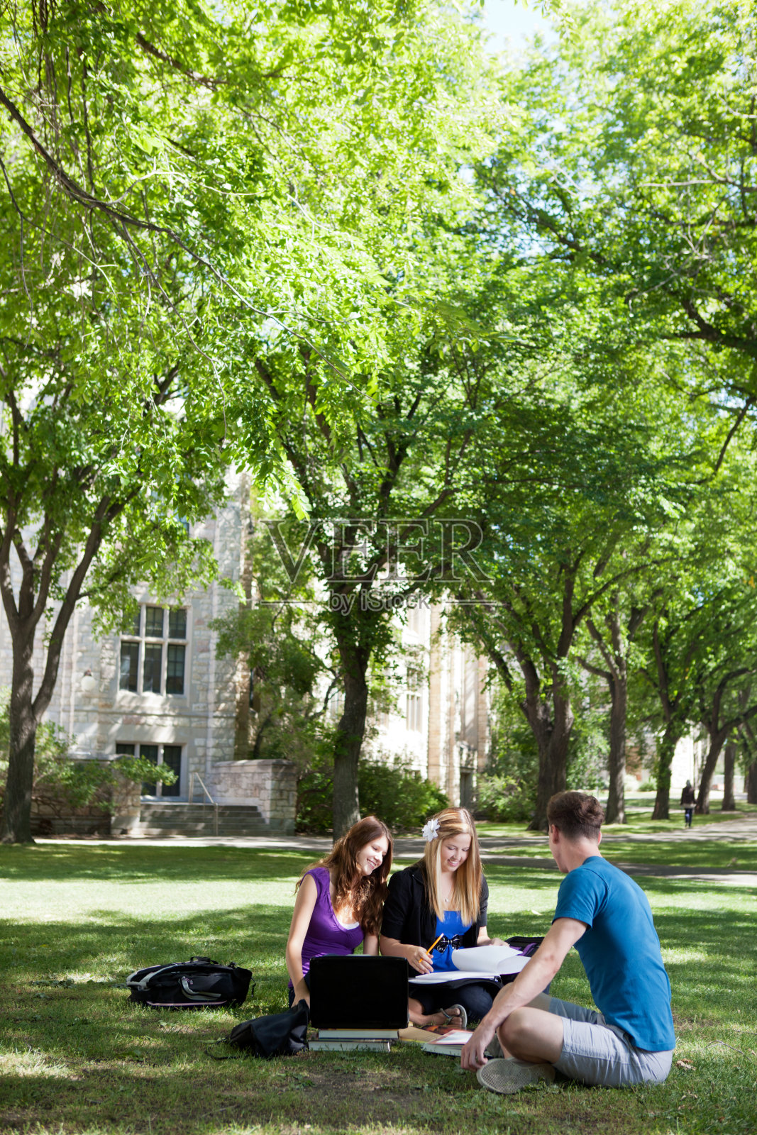 三个学生在户外学习，后面是大学照片摄影图片
