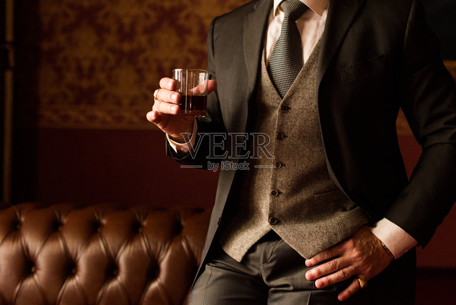 时髦的新郎手里拿着一杯威士忌照片摄影图片