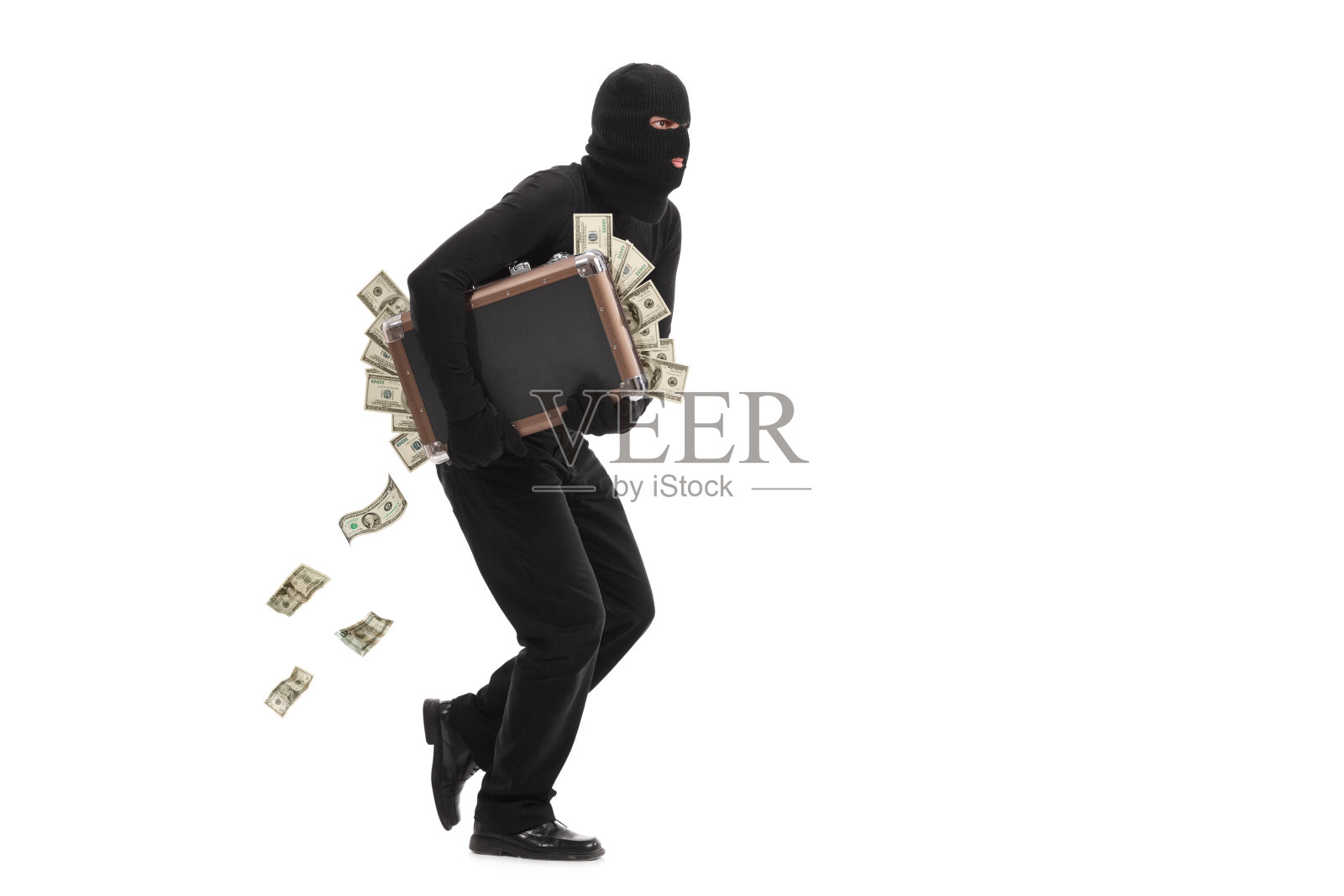 小偷带着一个装满钱的袋子逃跑照片摄影图片