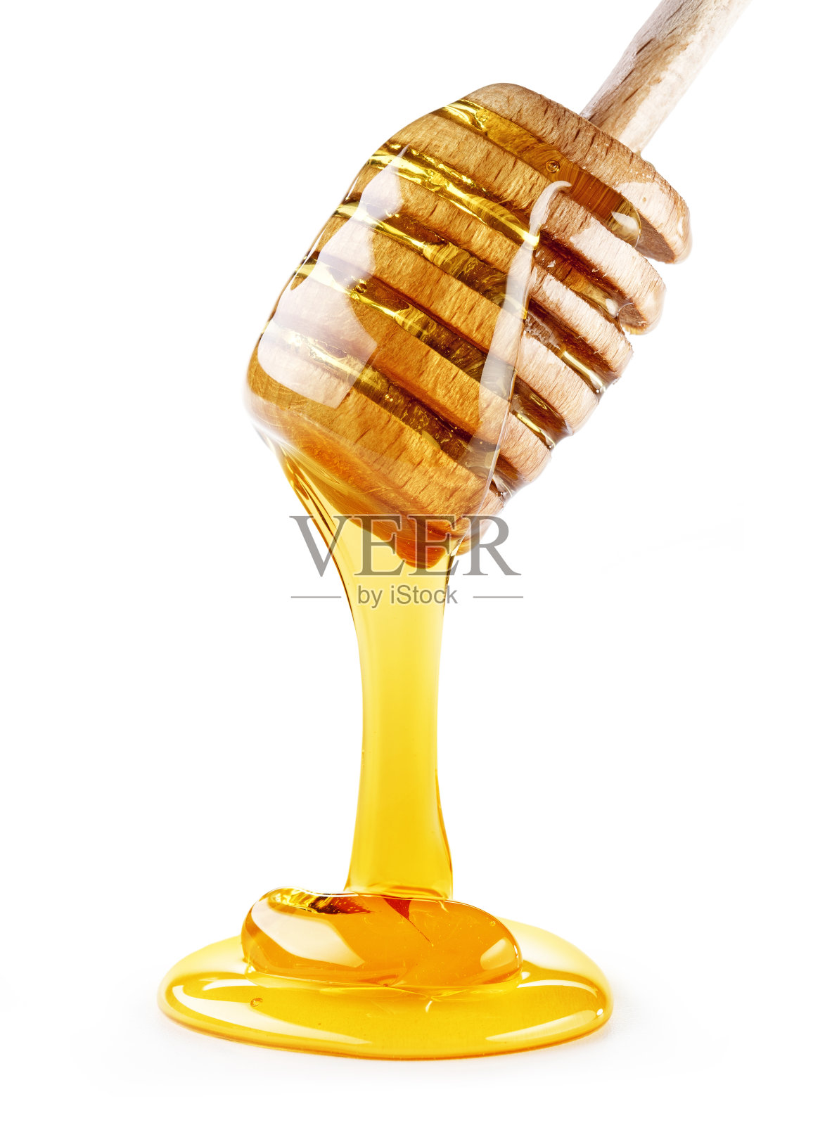 蜂蜜从木勺上滴下，孤立在白色背景上照片摄影图片