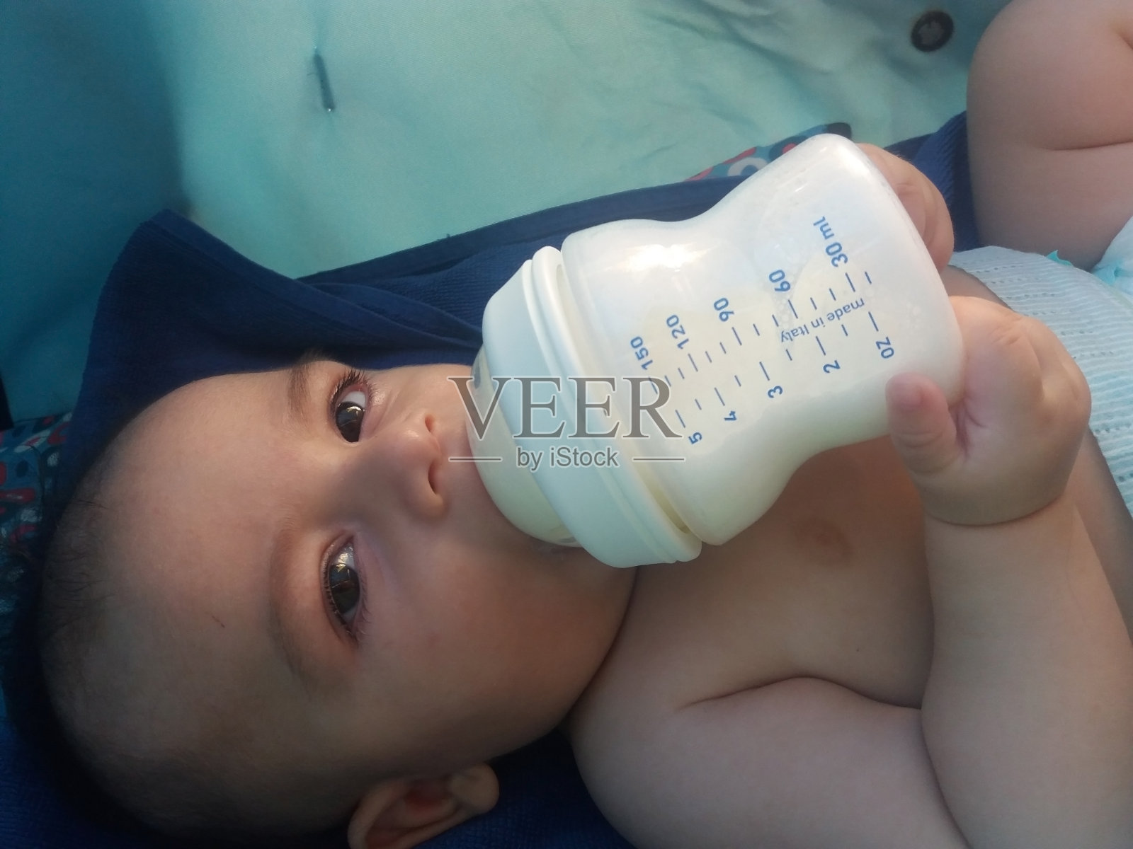 三个月大的男婴在喝奶瓶里的牛奶照片摄影图片