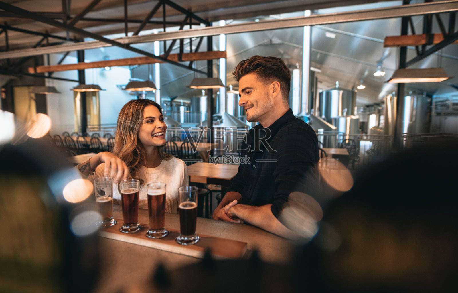 一对夫妇在啤酒厂酒吧品尝啤酒照片摄影图片