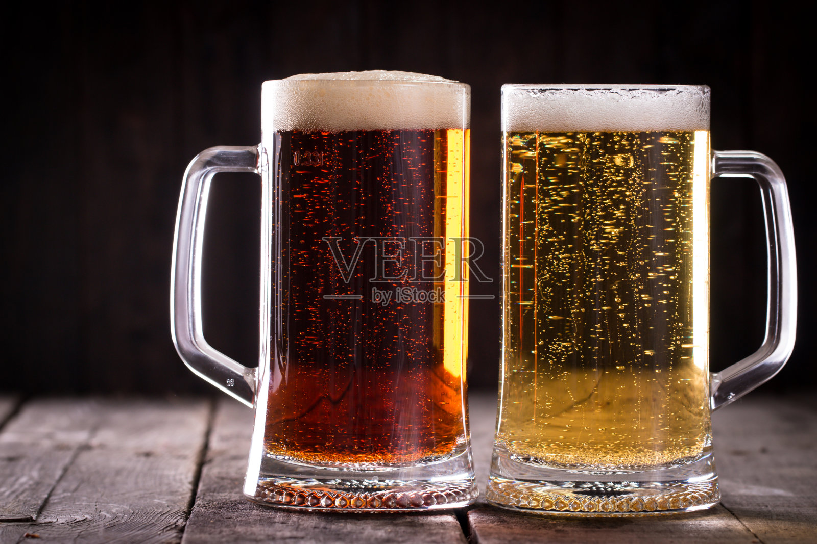 一杯冰凉的黑啤和淡啤，背景颜色较深照片摄影图片