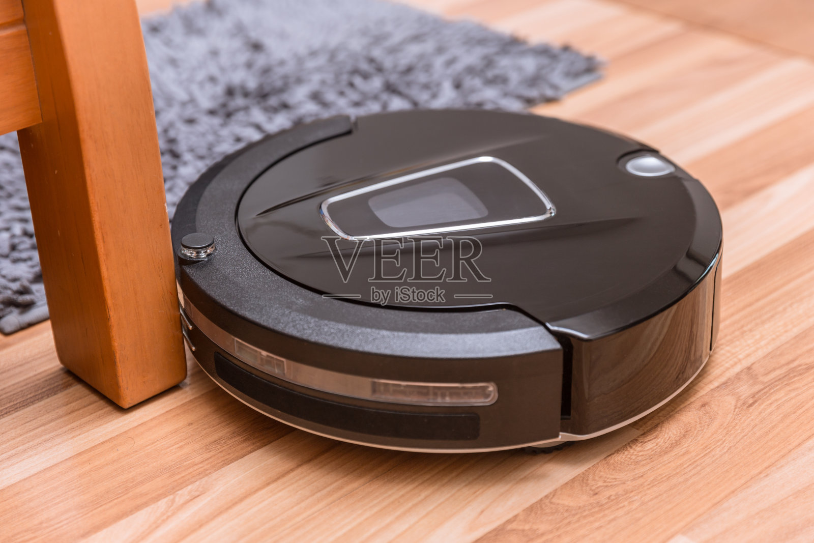 机器人真空吸尘器在强化木地板和地毯清洁照片摄影图片