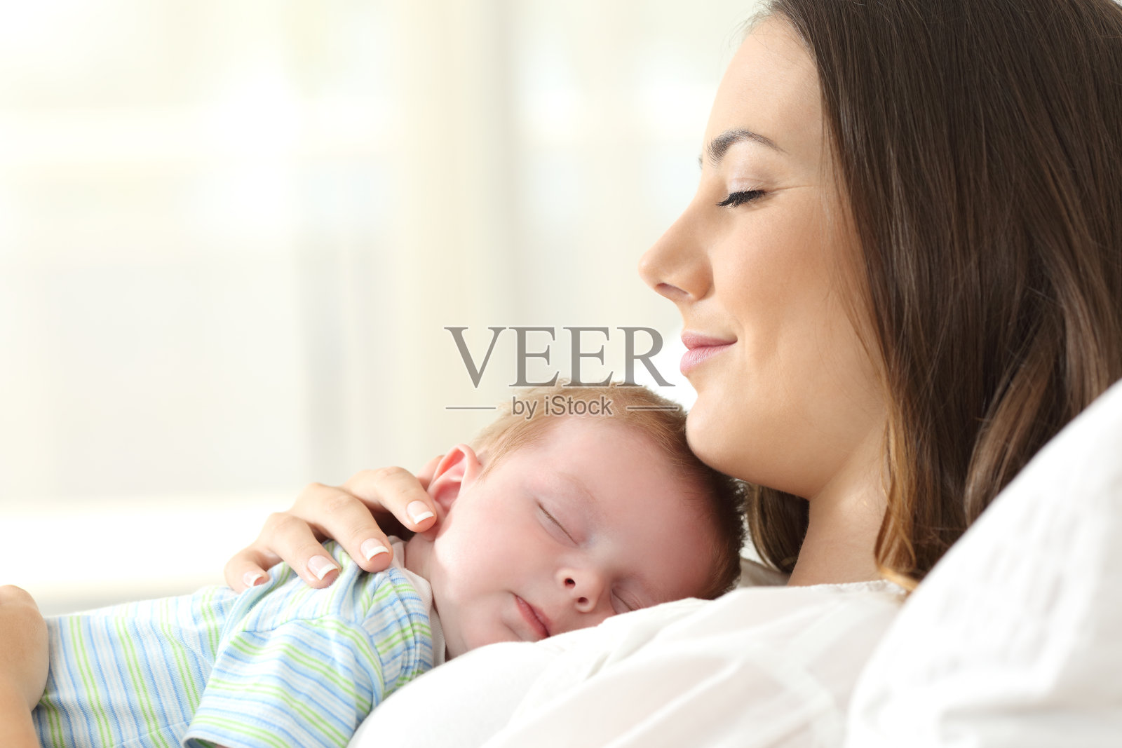 一个快乐的妈妈和她的孩子睡觉的简介照片摄影图片