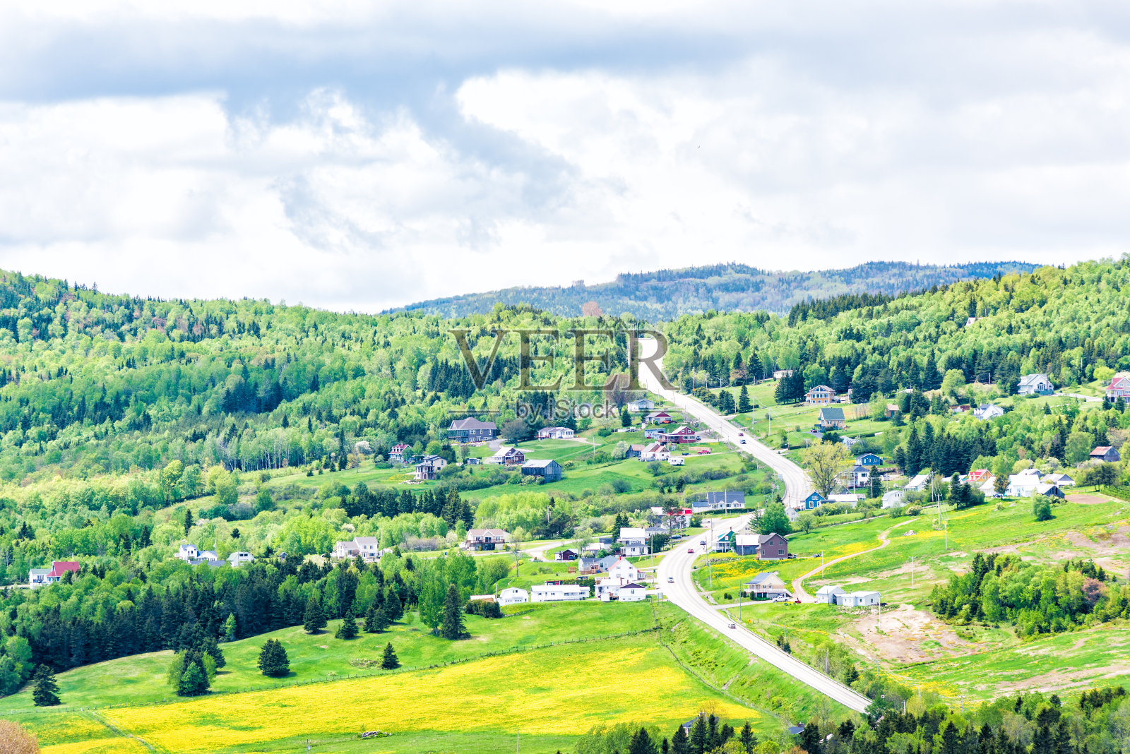 Les Eboulements, Charlevoix，魁北克，加拿大城市景观或天际线与主要高速公路陡峭弯曲的道路垂直向上，patch农场绿色的蒲公英田，分散的村庄房屋照片摄影图片