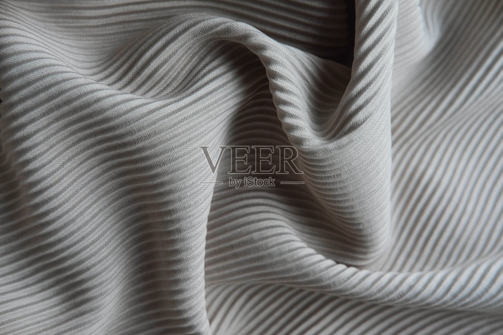这种织物呈波浪状排列。黑白帆布材质的纺织品。照片摄影图片
