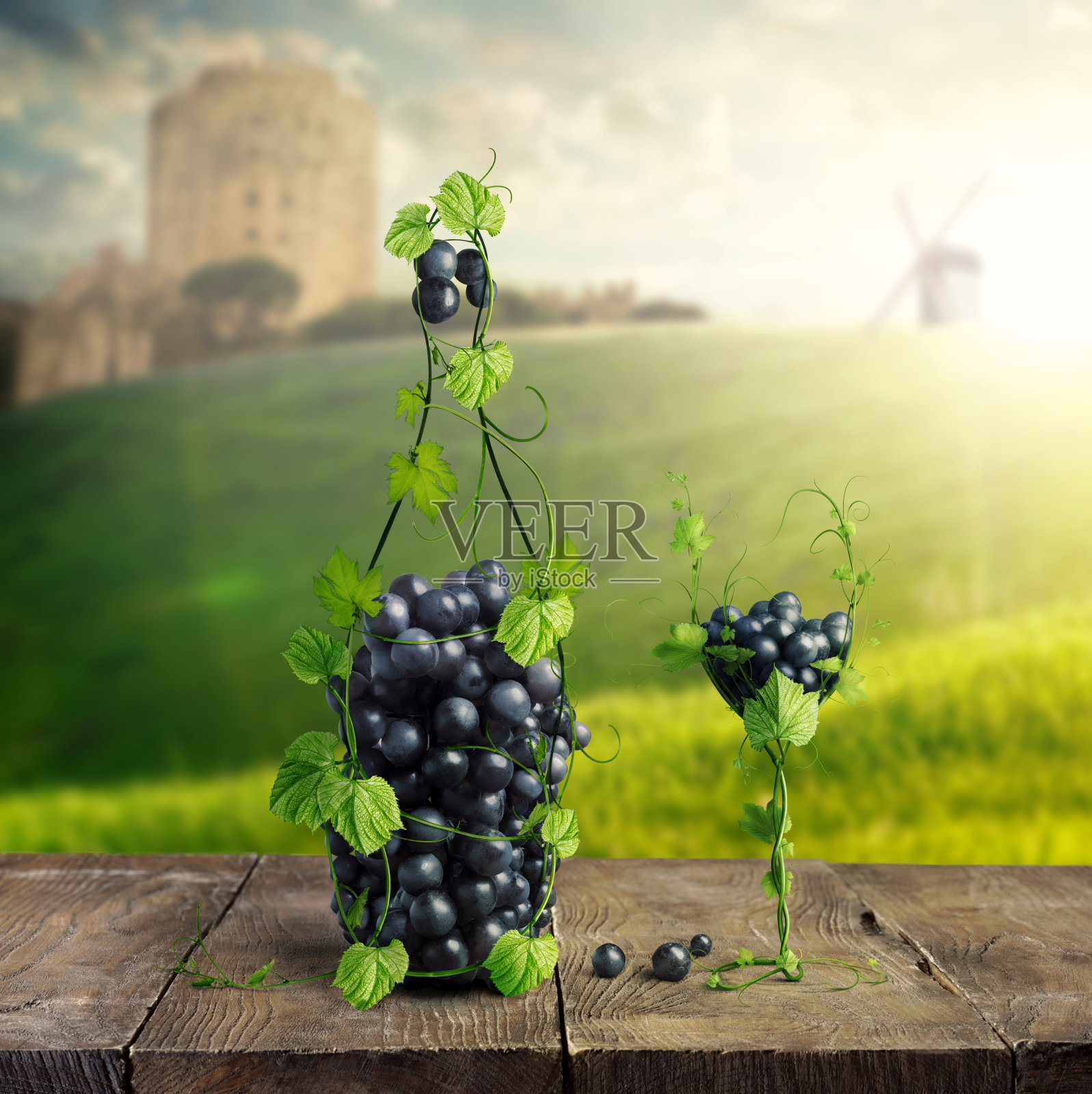 一瓶葡萄酒和一个由葡萄叶子和一串葡萄制成的玻璃杯在一个木制的背景照片摄影图片