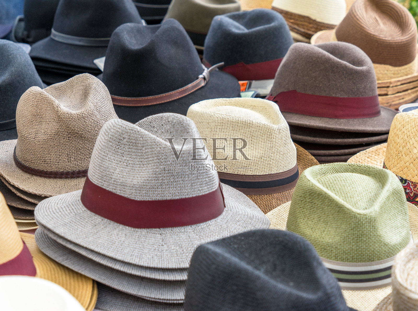 许多不同形状和颜色的男人帽子在一个展示出售照片摄影图片