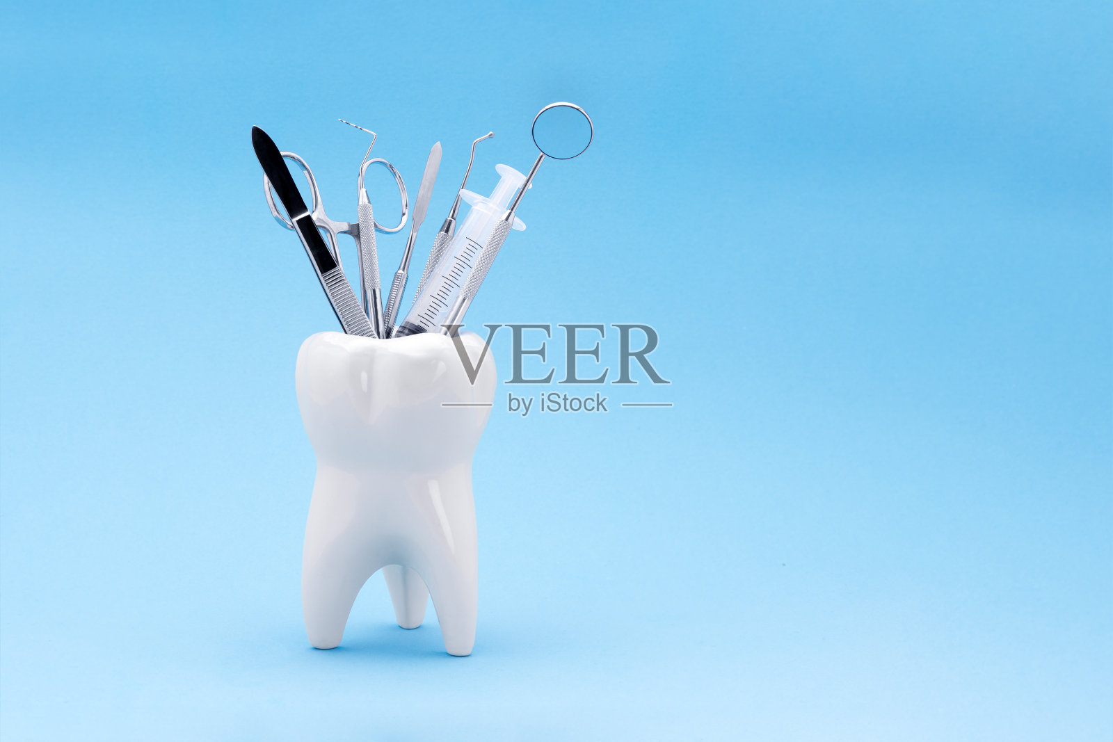 牙齿模型在一个支架的形式，里面有牙科仪器。在牙科中使用的背景和复制空间的概念照片摄影图片