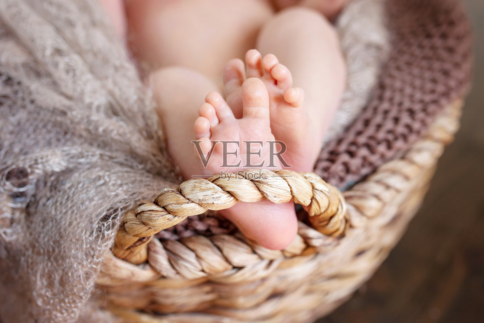 近距离的照片上的新出生的婴儿脚编织格子在一个wattbasket照片摄影图片