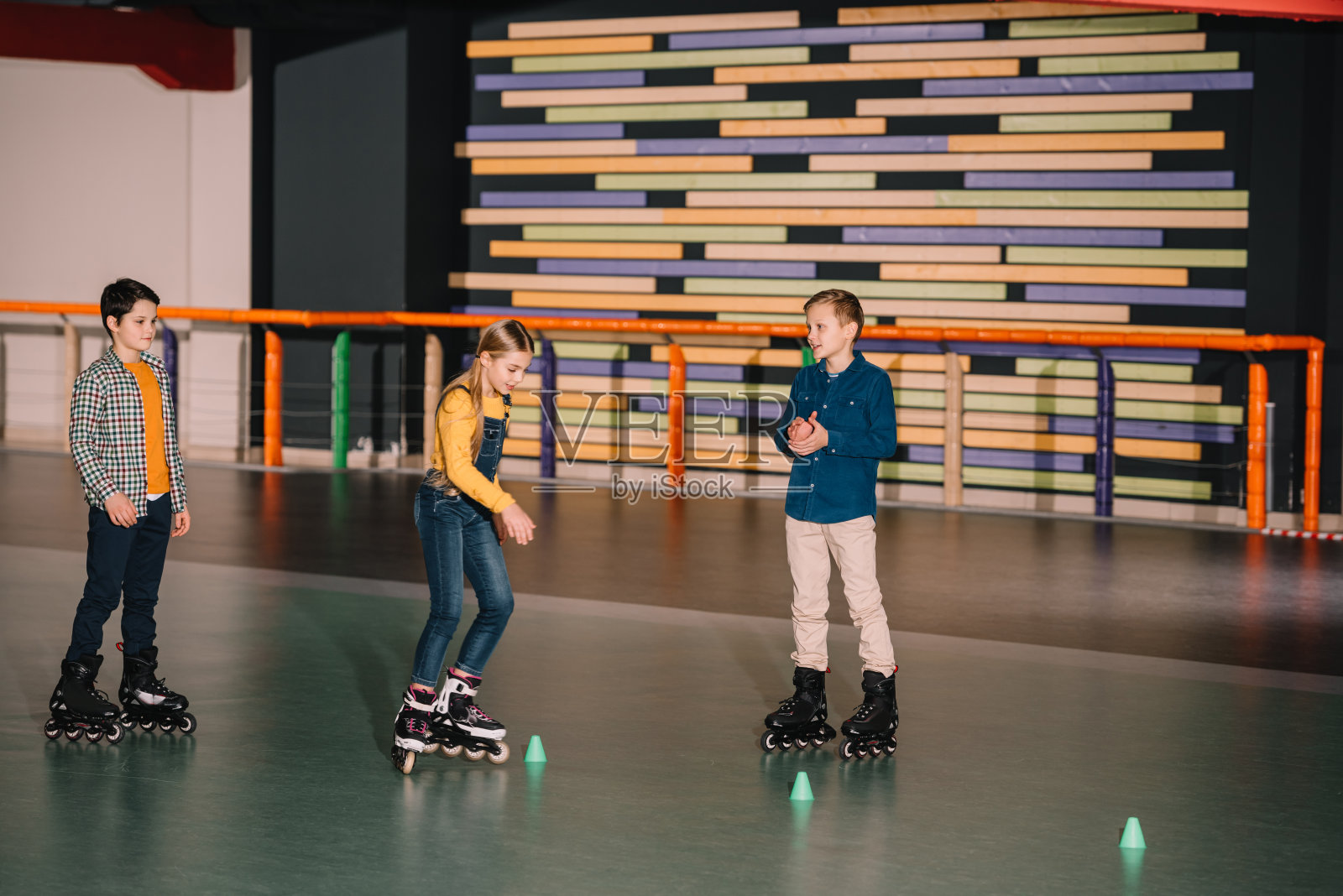 青少年前轮滑运动员一起在溜冰场练习滑冰照片摄影图片