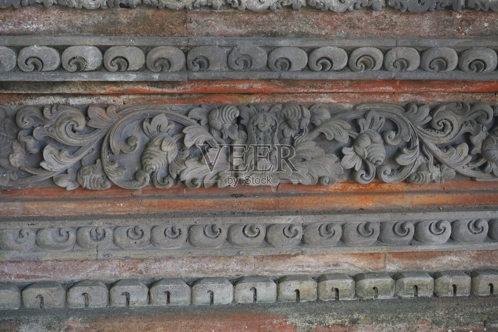 印度尼西亚巴厘岛一座寺庙墙上复杂的石雕装饰照片摄影图片