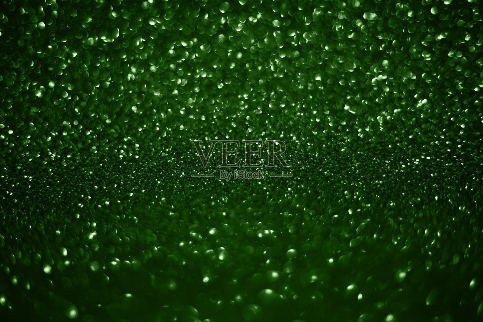 绿色亮晶晶的灯光与节日背景纹理。照片摄影图片