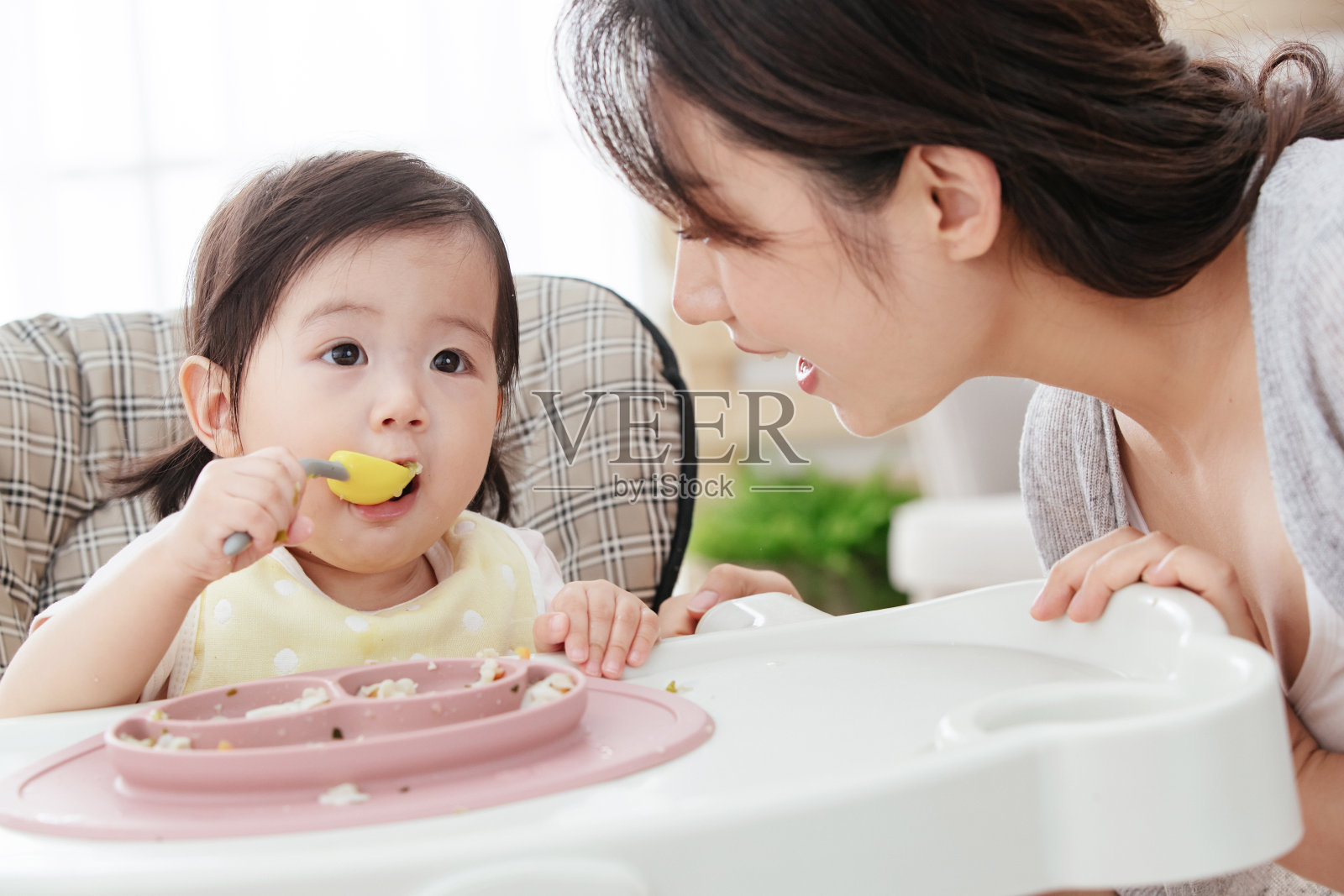 妈妈喂宝宝吃饭照片摄影图片