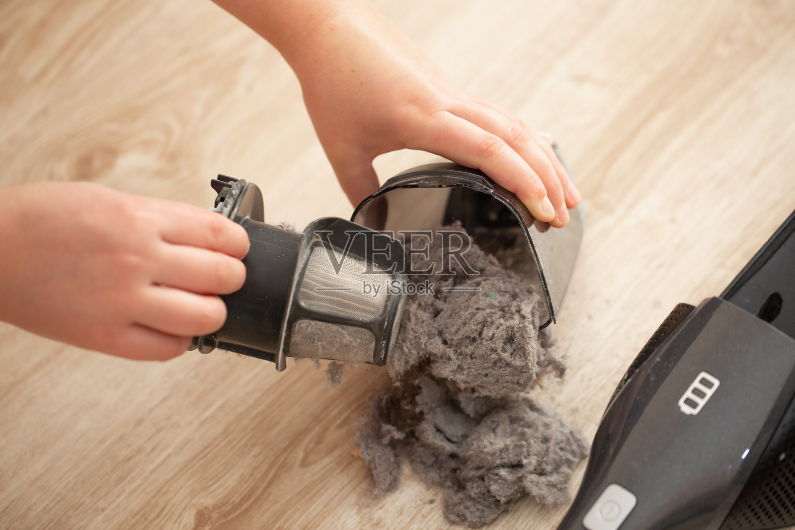 手真空吸尘器的过滤网严重堵塞、肮脏，吸尘器上有灰尘和粉末照片摄影图片