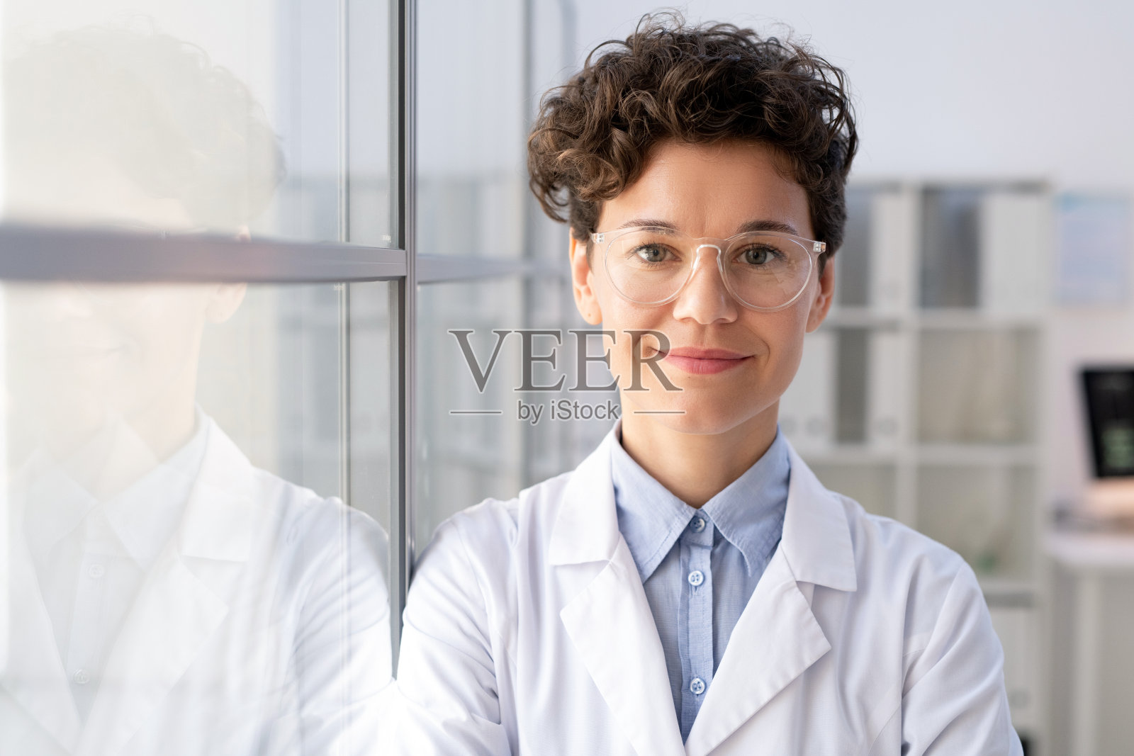 穿着白大褂，戴着眼镜的科学实验室年轻成功的女工作人员照片摄影图片