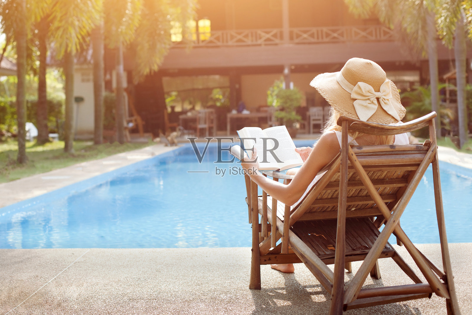 女游客放松附近豪华游泳池在酒店照片摄影图片