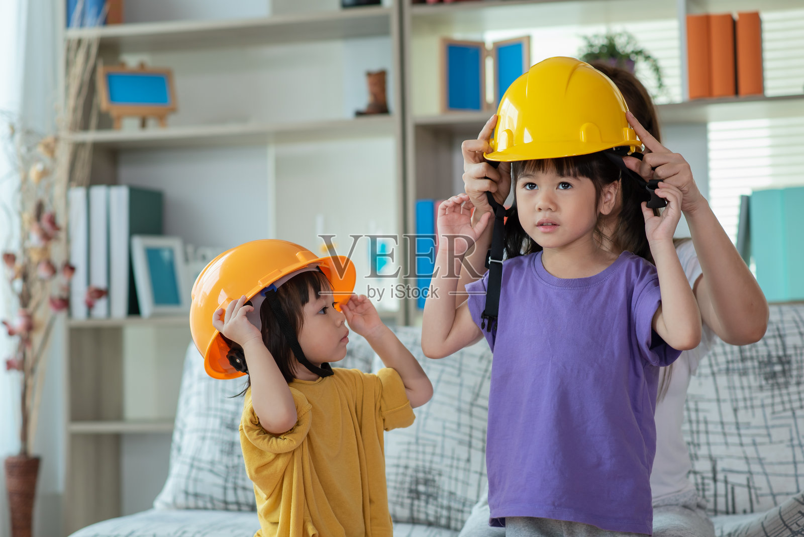 亚洲母亲帮助女儿戴工程师头盔，教育和职业理念照片摄影图片
