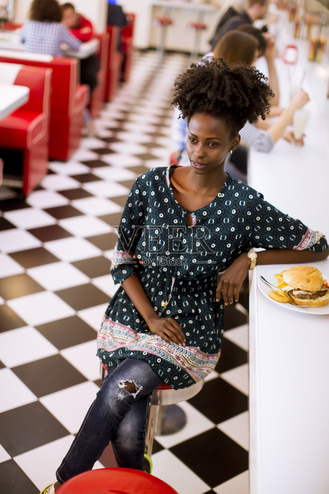餐厅里一个年轻的非裔美国女人照片摄影图片