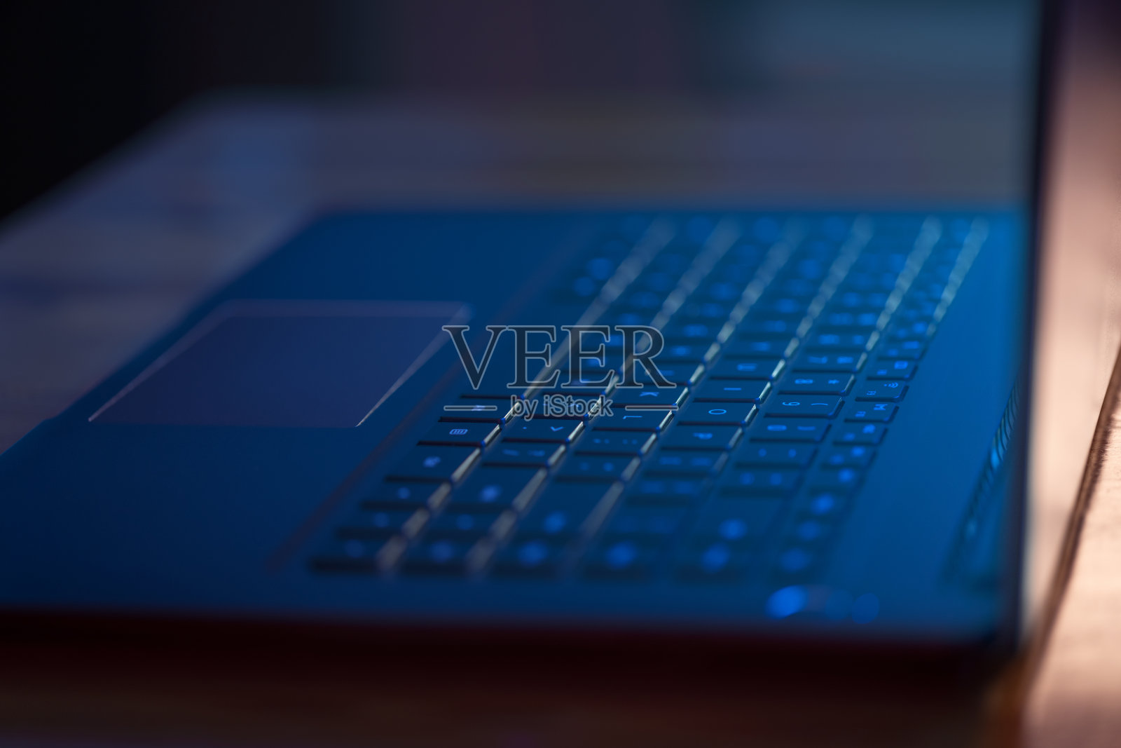 笔记本电脑在黑暗中与蓝色辉光的屏幕照片摄影图片