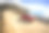 一辆红色汽车飞驰在大苏尔的比克斯比桥上素材图片