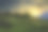 绿色的山坡在落日的余晖下素材图片